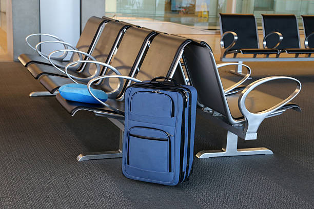 istock Blue suitcase at an airport lobby. 476557528