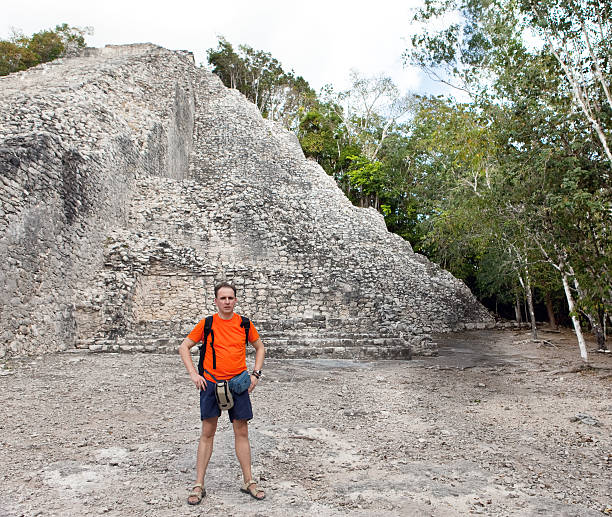 istock tourist against pyramid ruins Mexico. Archeologic zone Kabah. 476557978