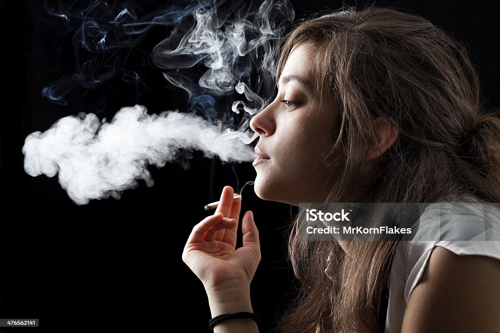 Smoking Woman Woman Smoking a Cigarette on Black Background Smoking - Activity Stock Photo