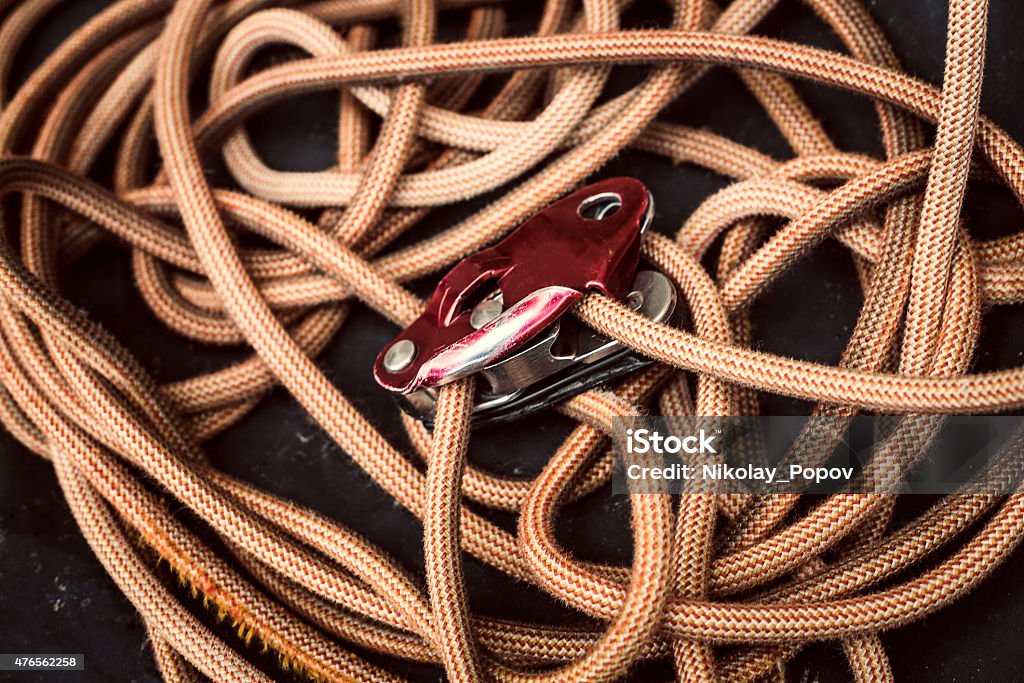 Rope climbing. A rope with a safety device on a dark background. 2015 Stock Photo