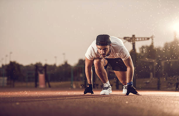 istock Male athlete in start position ready for running on rain. 476562414
