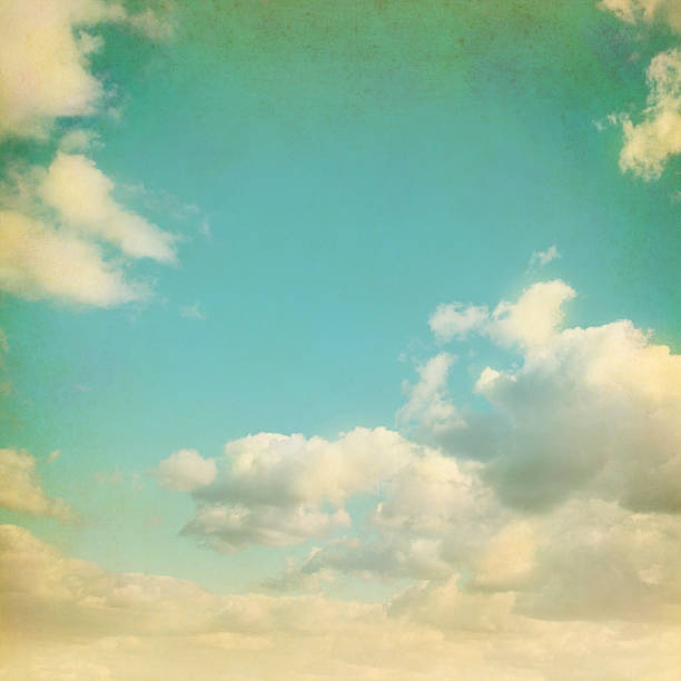 istock Old paper background with blue sky and white clouds 476563542