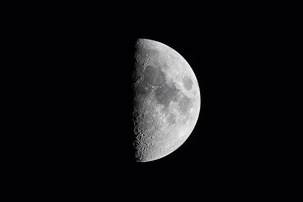 istock Half moon, or first quarter moon phase, against a black sky. 476567324