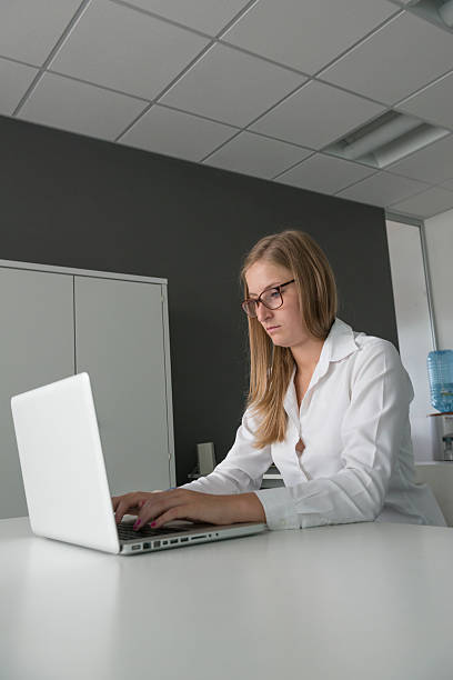 istock Girl with laptop in her office 476567983