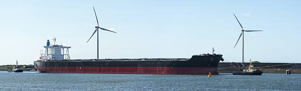 istock Tug boats escorting Blulk Carrier  to Ijmuiden locks 476568421