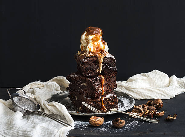Fudgy Brownies tower with salted caramel, walnuts and ice-cream