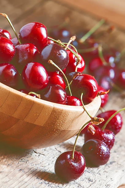 istock Fresh cherries in a wooden bowl, selective focus 476568940
