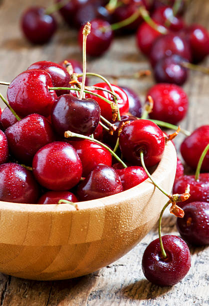 istock Fresh cherries in a wooden bowl, selective focus 476568944