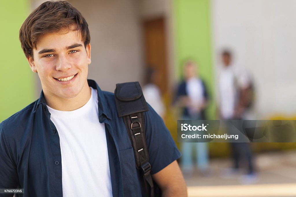 teen boy carrying schoolbag smiling teen boy carrying schoolbag Teenager Stock Photo