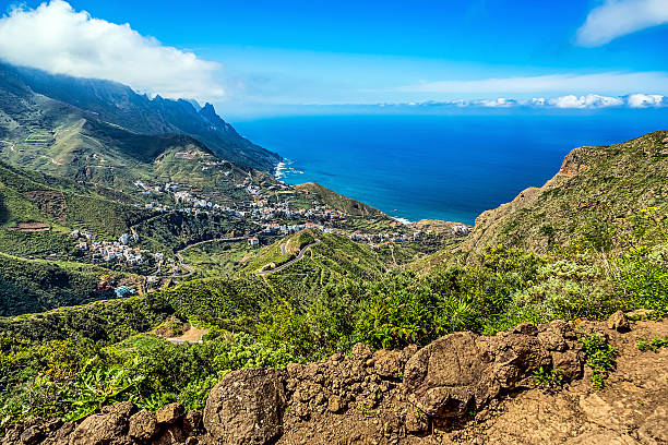 istock Mountain and clouds with village 476573114
