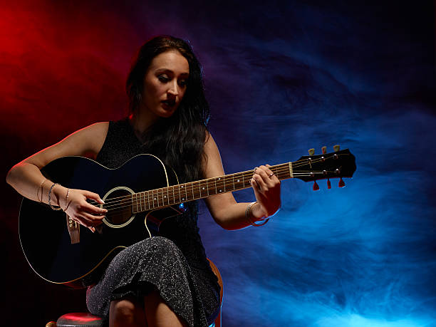 istock Guitarist woman 476573864