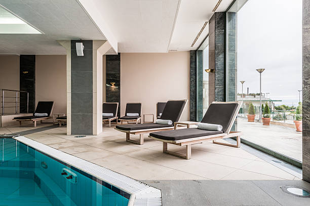 istock Deckchairs near indoors swimming pool 476574440
