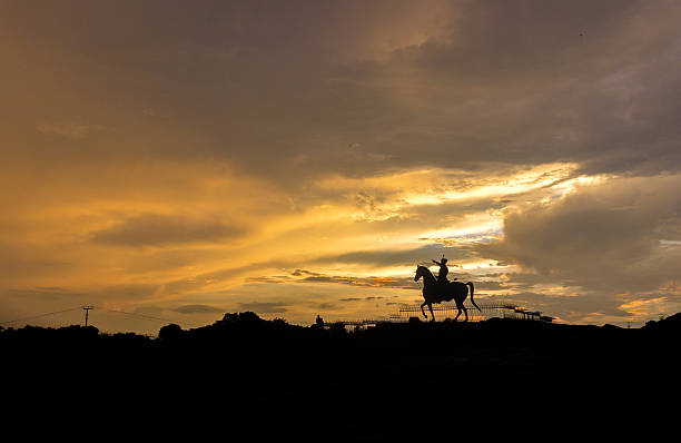 Silhouette of Rao Jodha Ji Statue after sunset in golden hour at jodhpur, Rajasthan, India
