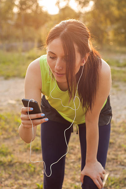 istock Woman setting the music playlist for the workout. 476579712
