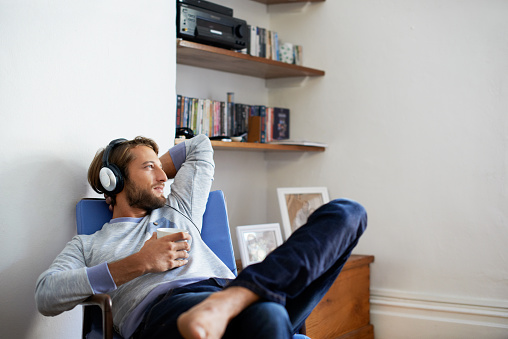Shot of a young man having coffee while listening to music at homehttp://195.154.178.81/DATA/i_collage/pu/shoots/804608.jpg