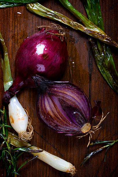 Roasted red onion on dark wooden background stock photo
