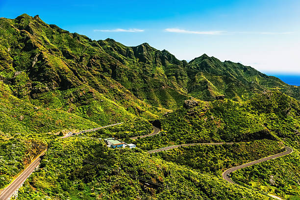 istock Green mountains or rocks valley with winding road 476582792