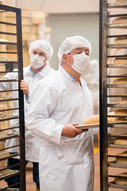 istock Men working at a food factory 476587308