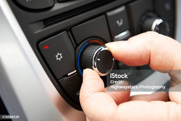 Hand Adjusting Car Air Conditioning Control On Dashb Stock Photo - Download Image Now