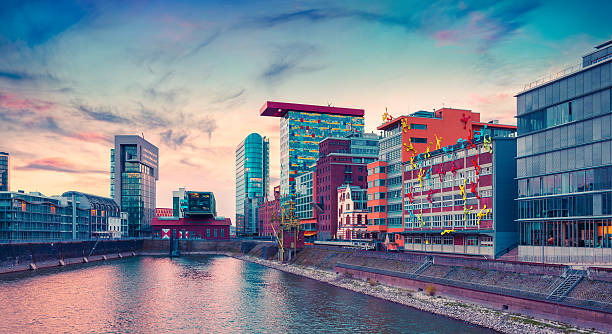 Colorful view of Rhine river at evening in Dusseldorf Colorful view of Rhine river at evening in Dusseldorf. Medienhafen in the soft sunset light, Nordrhein-Westfalen, Germany, Europe. Instagram toning. media harbor photos stock pictures, royalty-free photos & images