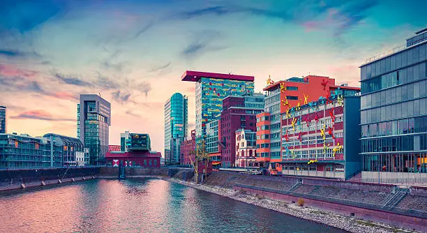Colorful view of Rhine river at evening in Dusseldorf. Medienhafen in the soft sunset light, Nordrhein-Westfalen, Germany, Europe. Instagram toning.