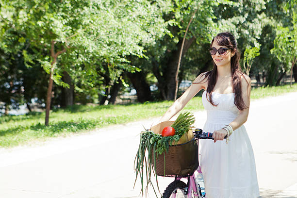 istock Woman with bicycle returns from shopping 476593254