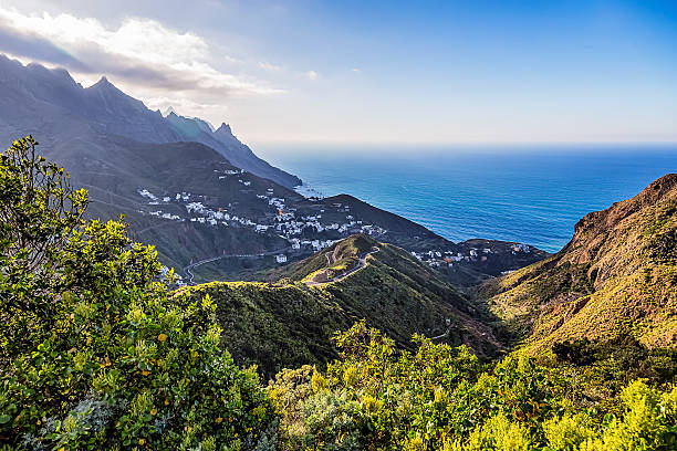 istock Village in mountains with clouds near ocean 476593268