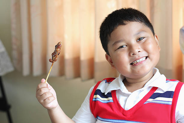 istock The boy eating a delicious pork. 476594429