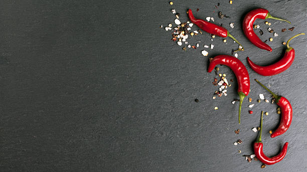 istock chalk board background with red chili peppers 476594490