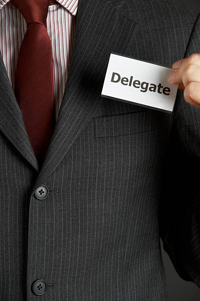 istock Businessman Attaching Delegate Badge To Jacket 476594654