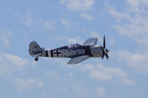Chino, California,USA- May 2,2015. German vintage WWII Fw 190 airplane flying at the 2015 Planes of Fame Air Show in Chino, California. The 2015 Planes of Fame Air Show features 3 days of vintage and modern aircraft performing in the sky and many static aircraft displays for the general public to view.