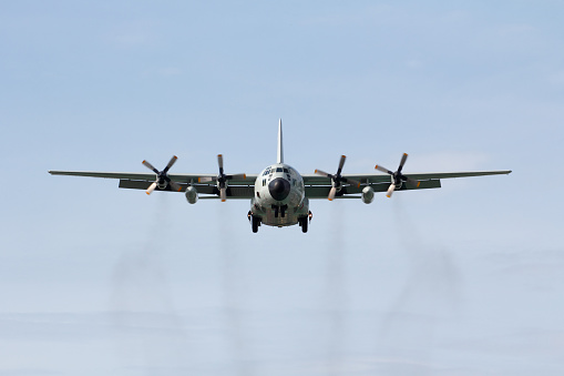 The military transport airplane (C-130) head on landing