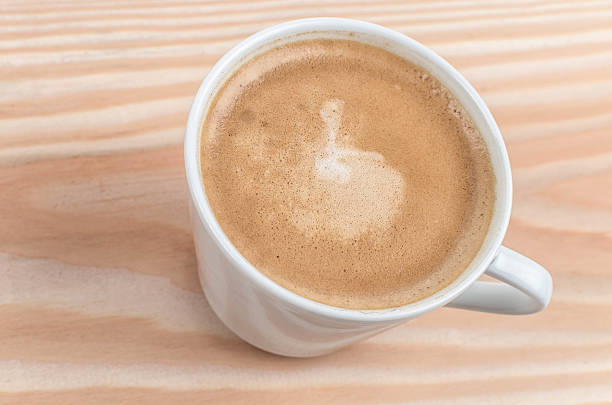 istock Cup of coffee from above on wooden table 476598984