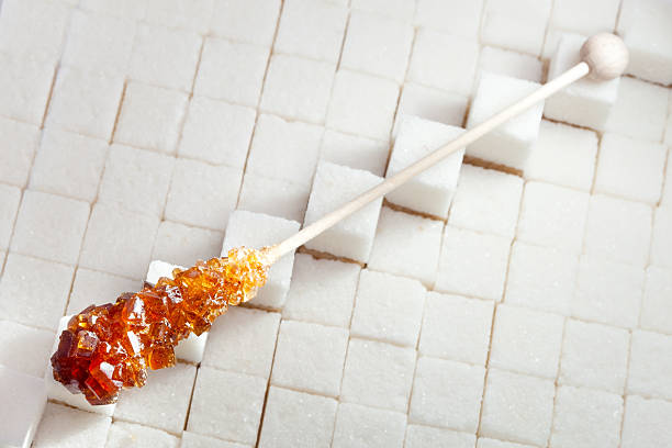 istock candy brown sugar on a stick lies in white lumpy 476600676