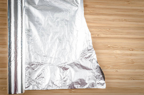 lámina de aluminio - rolled up foil paper gray fotografías e imágenes de stock