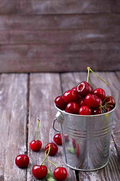istock fresh cherries on wooden table 476601084