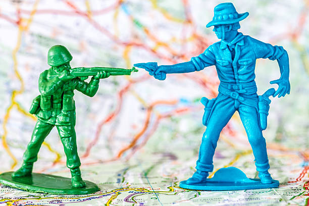 istock Armed combat between a soldier and a cowboy toy figurine 476603796