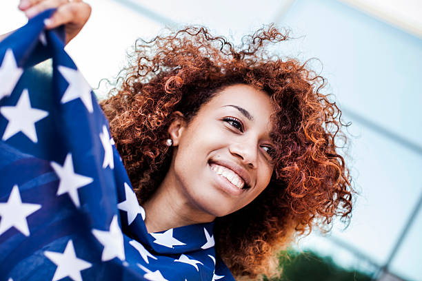istock Beautiful afro woman holding US flag 476603930