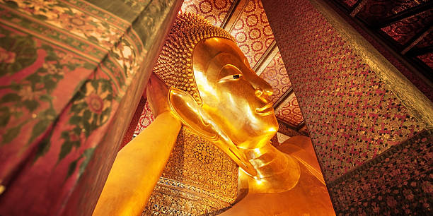 istock Reclining Buddha gold statue face. Wat Pho, Bangkok, Thailand 476604336