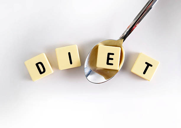 istock diet block word over sugar pile spoon taking one letter 476604734