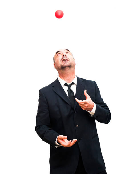 istock Businessman that is juggling with a red balls 476604926