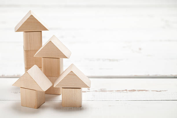 istock Wooden toy house on white table 476605744