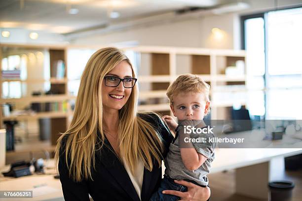 Businesswoman With Small Child In The Office Stock Photo - Download Image Now - Child, Working, Family