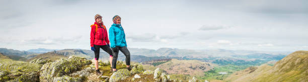 istock Young hikers on mountain top overlooking panoramic vista Lake District 476607964