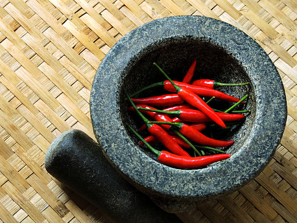 istock THAI CUISINE : Red chillies in Mortar with Pestle 476609324