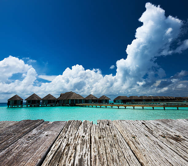 istock Beautiful beach with water bungalows 476609326