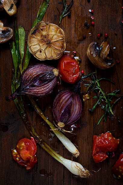 Grilled onions and vegetables on cutting board stock photo
