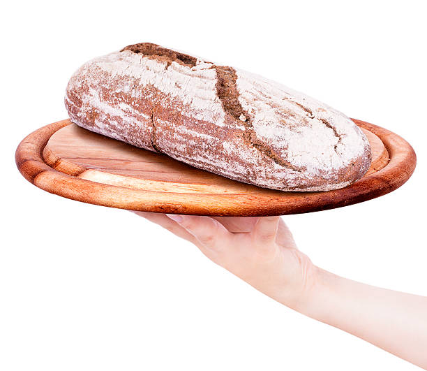 istock Bread on a wooden tray with  waiter hand 476610823