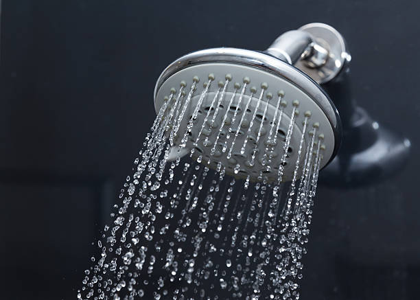 istock shower head in bathroom with water drops flowing 476611624