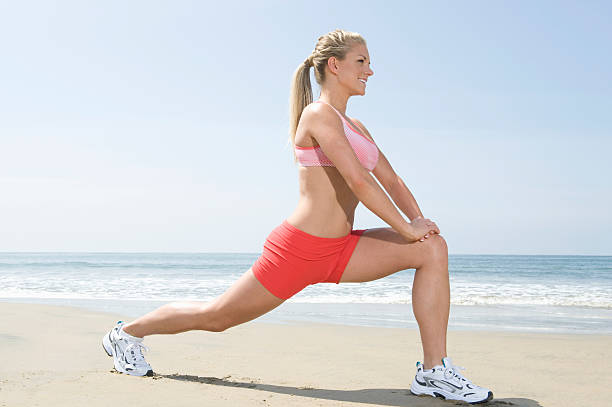 istock Woman Doing Fitness Exercise On Beach 476612123